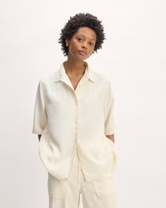 About This Style.  This piece features an oversized fit, shirt collar, front button closure and cuffs, short sleeves, and straight hem. Relaxed Button-up Shirt With Rolled Sleeves, Classic Shirt With Roll-up Sleeves For Day Out, Daywear Collared Shirt With Button Cuffs, Relaxed Fit Shirt With Roll-up Sleeves And Shirttail Hem, Lapel Collar Shirt With Button Cuffs For Daywear, Casual Short Sleeve Top With Button Cuffs, Collared Shirt With Button Cuffs For Day Out, Relaxed Fit Shirt With Roll-up Sleeves For Daywear, Relaxed Fit Shirt With Shirttail Hem For Daywear