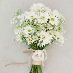 a bouquet of white flowers tied with twine