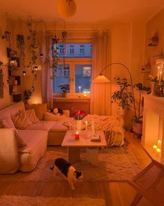 a living room filled with furniture and a fire place next to a window covered in candles