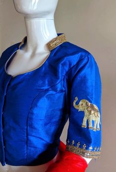 Royal blue raw silk blouse with beautiful hand embroidery paired with a full flared orange elephant embroidery brocade skirt. The blouse is collared with a back opening. The collar and the back opening border is embellished with zardosi hand embroidery. The sleeve has embroidered elephants. The skirt waist had ties and is full flared with double lining. I will send a measurements sheet once you order for detailed measurements. Color is customisable. Please send a convo or note with your color pr Fitted Raw Silk Choli With Motifs, Blue Anarkali Blouse With Intricate Embroidery, Anarkali Style Blouse With Traditional Drape In Raw Silk, Anarkali Cotton Silk Choli With Motifs, Anarkali Choli In Cotton Silk With Motifs, Ceremonial Anarkali Fitted Choli, Ceremonial Fitted Choli, Blue Silk Blouse With Intricate Embroidery, Fitted Cotton Silk Choli With Motifs