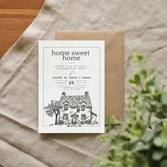 a card with the words home sweet home on it next to a potted plant