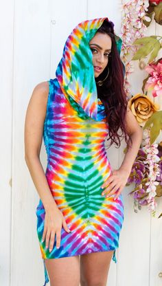 All tie dyes are One-Of-A-Kind. Like mother natures snowflakes no two will ever be exactly alike. Each garment is hand made in San Francisco, CA then carefully and boldly tied and dyed by one of the Jammin' On Master Tie Dyers. Each tie dye garment has been infused with positive energy from expert hands. The Huntress Cinch Dress, proudly one of the most versatile Onesie in our collection. The abundant cowl can be worn as hood, shawl, off the shoulder, as strapless top or simply down. Design Feat Creative Dress Design, Tie Dye Inspiration, Summer Tie Dye Festival Dress, Rainbowcore Fashion, Flowy Tie-dye Dress For Festival, Cool Tie Dye Patterns, Hand-dyed Tie-dye Dresses For Vacation, Tie Dye Tips, Tie Dye Onesie