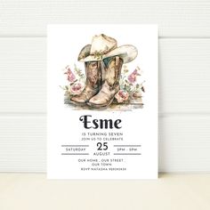 an image of a birthday party card with cowboy boots and flowers on the front, in white