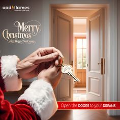 a person holding a key to a door with the words merry christmas written on it