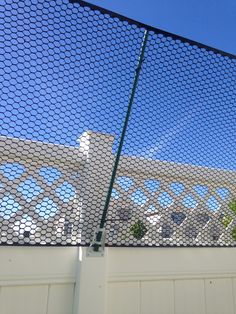 a white fence with a blue sky in the background