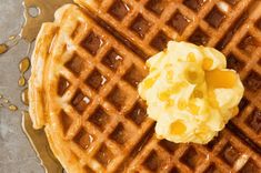 two waffles with butter and syrup on top