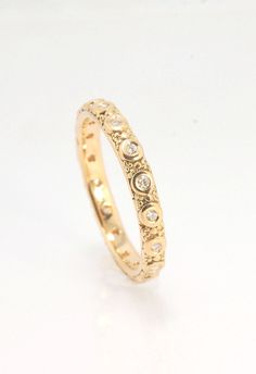 The subtle sparkle of this band is a delight! This is a 3mm patterned band with ethically sourced, 1.5 mm SI2-SI3 F+ Round Diamonds bezel set in each disc around the band. This is a cast version of a striking patterned band I originally made in fine silver using the process of Granulation. I then make a mold of the ring and pull a wax copy and then I can cast using the lost wax process in the size and metal of your choice. I am currently offering this Diamond Eternity Band in 14k yellow gold, 18 14k Gold Eternity Band With Rose Cut Diamonds, Classic Gold Eternity Band With Rose Cut Diamonds, Stackable 14k Yellow Gold Eternity Band, Dainty Yellow Gold Eternity Band, Dainty Yellow Gold Stackable Eternity Band, Elegant Gold Eternity Band With Rose Cut Diamonds, Yellow Gold 14k Rose Cut Diamond Eternity Band, Classic Yellow Gold Eternity Band With Rose Cut Diamonds, Dainty Stackable Yellow Gold Eternity Band