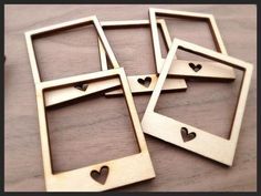 four wooden frames with hearts cut out of them