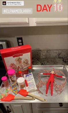 the elf is on top of the kitchen counter next to some items that have been put together