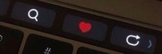 the keyboard is illuminated with red heart and q on it's display, as well as other symbols