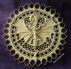 a crocheted doily on a purple background