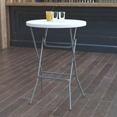 a white table sitting on top of a wooden floor