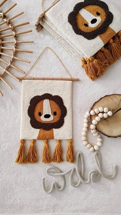 three handmade wall hangings with animals on them