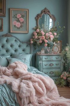 a bedroom with blue walls and pink flowers on the bed, dressers and mirror