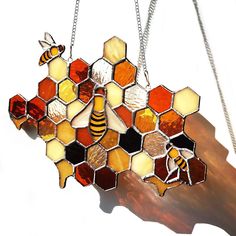 a stained glass honeycomb hanging from a chain