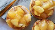 three pineapple desserts sitting on top of a table next to a fork and spoon