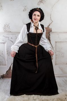 A historical renaissance costume inspired by the Spanish 16-century court and stories of passion in the dark corridors of Escorial palace. The dress was developed based on 16th and 17th-century paintings. With its conical tight corset, wide skirt, and long removable sleeves, as well as dark coloring, the costume bears a distinguishing mark of 16th-17th century Spanish fashion, which has been quite popular in Europe. The costume consists of a skirt, an adjustable corset, a chemise, and a beret. A Baroque Victorian Dress For Costume And Medieval Festivals, Baroque Victorian Dress For Costume Parties And Medieval Festivals, Historical Ornate Medieval Dress For Fancy Dress, Victorian Medieval Dress For Costume Parties And Festivals, Victorian Medieval Dress For Costume Party, Victorian Medieval Dress For Fancy Dress, Historical Baroque Medieval Dress For Fancy Dress, Baroque Medieval Dress For Fancy Dress, Regency Style Corset Dress For Costume Events