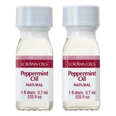 two bottles of peppermint oil sitting next to each other on a white background