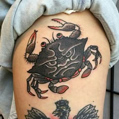 a woman's thigh with tattoos on it and an image of a crab in the middle