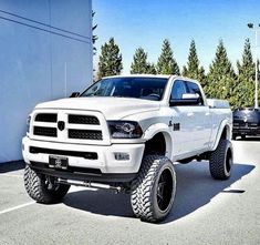 a white ram truck parked in a parking lot