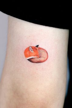 a small fox tattoo on the ankle