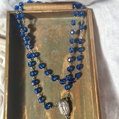 Beautiful blue colored vintage rosary . Acrylic medium Faceted beads and a silver detailed crucifix ,and a Lourdes Holy Water medallion centerpiece and links. Rosary is in perfect condition! Beautiful for a decor piece. The colors are beautiful! Nice for making a Altered Necklace... 22 inch drop...so total length is 44 inches Handmade Blue Rosary For Jewelry Making, Blue Crucifix Necklace For Spiritual Wear, Blue Crucifix Necklace For Spiritual Purposes, Adjustable Blue Rosary With Miraculous Medal, Rosary With Faceted Beads And Crucifix, Blue Rosary With 8mm Beads And Crucifix, Blue Rosary With 8mm Beads In Cross Shape, Handmade Blue Rosary With Cross Shape, Handmade Blue Rosary With Cross