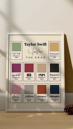 the taylor swift color palette is displayed in front of a pine cone on a table