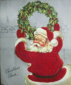 an old fashioned christmas card with santa claus holding a wreath on it's back