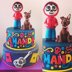 there is a cake decorated with two dogs on the top and one has a guitar