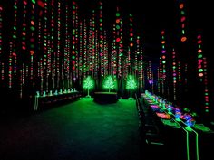 a long table is lit up with colorful lights