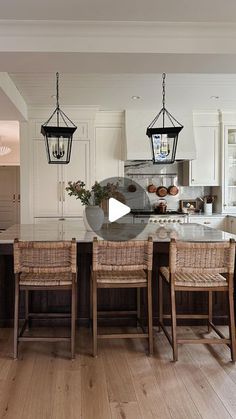 the kitchen is clean and ready to be used for dinner or breakfast time, as well as an island with four chairs