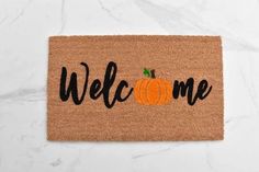 a welcome mat with a pumpkin on it