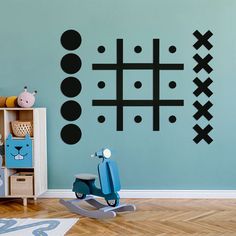 a child's room with blue walls and black wall decals on the wall