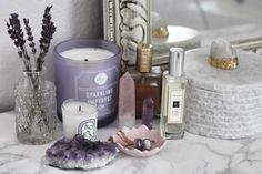 candles, rocks and other decorative items on a marble counter