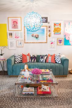 a living room filled with lots of furniture and pictures on the wall above it's coffee table