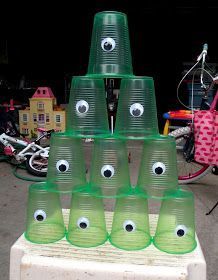 there are many green cups with eyes on them