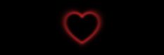 a red heart is glowing in the dark