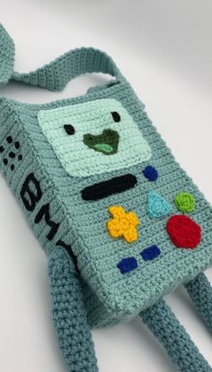 a crocheted cell phone case is made to look like a robot