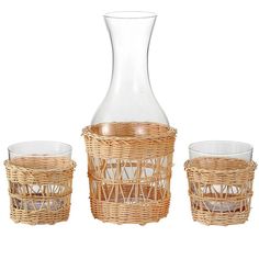 three glasses and a vase are sitting next to each other