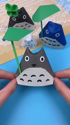 someone is holding up some paper crafts to show how they are doing something with their hands