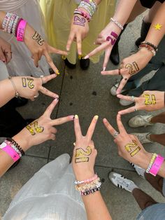 a group of people with numbers painted on their fingers