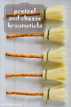 four pieces of cheese are arranged in the shape of toothpicks