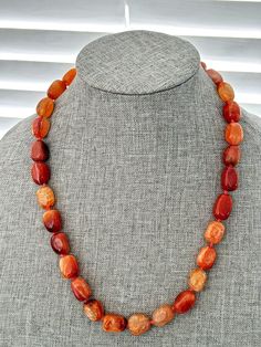 Elevate your style with this stunning Snake Skin Agate Necklace! 🐍🧡 With 29 beautifully polished oval gemstones in a mix of amber and orange colors, this 20" necklace is perfect for any occasion. The toggle closure adds a touch of elegance to this gemstone beauty. #SnakeSkinAgate #GemstoneNecklace #OrangeAndAmber #FashionStatement #JewelryLover 🌟  #eBay #Agate #Gemstone Agate Gemstone Necklaces With Round Beads, Elegant Amber Agate Beaded Necklaces, Amber Carnelian Necklaces With Natural Stones, Bohemian Oval Agate Necklace, Agate Necklaces With Oval Beads For Gifts, Adjustable Tumbled Gemstone Necklaces, Agate Necklace With Oval Beads For Gifts, Agate Necklace With Oval Beads For Gifting, Oval Agate Gemstone Bead Necklaces