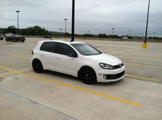 a white car parked in a parking lot