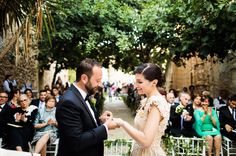 a man and woman standing next to each other in front of an outdoor wedding ceremony