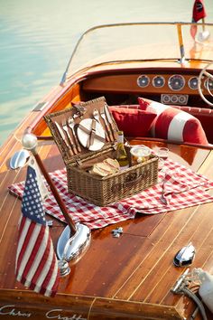 a picnic on the deck of a boat with an american flag table cloth and basket