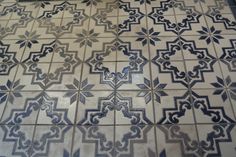 a tile floor with blue and white designs on it