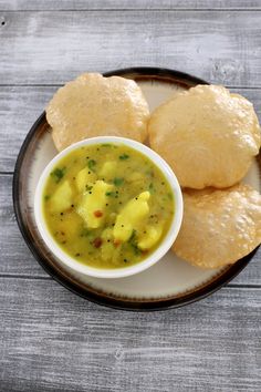 a bowl of soup and some pita bread on a plate