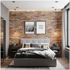 a bedroom with brick walls and flooring is pictured in this image, there are two framed pictures on the wall above the bed