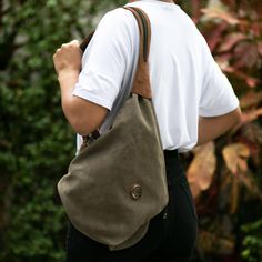 This innovative bag is designed by Peru's Karina and Maybee. Crafted from sturdy cotton canvas in clay the bag can be slung over one shoulder or converted into a backpack by unzipping the wide strap. The fully-lined bag is trimmed in supple brown leather and features zipper pockets on the interior and exterior to keep small items handy. Khaki Canvas Bag For On-the-go, Canvas Backpack With Removable Pouch For Daily Use, Casual Canvas Backpack, Casual Everyday Canvas Backpack, Khaki Canvas Travel Bag With Adjustable Strap, Khaki Canvas Bag With Adjustable Strap For Travel, Casual Canvas Hobo Bag For Everyday, Casual Canvas Shoulder Backpack, Casual Canvas Bucket Bag With Adjustable Strap